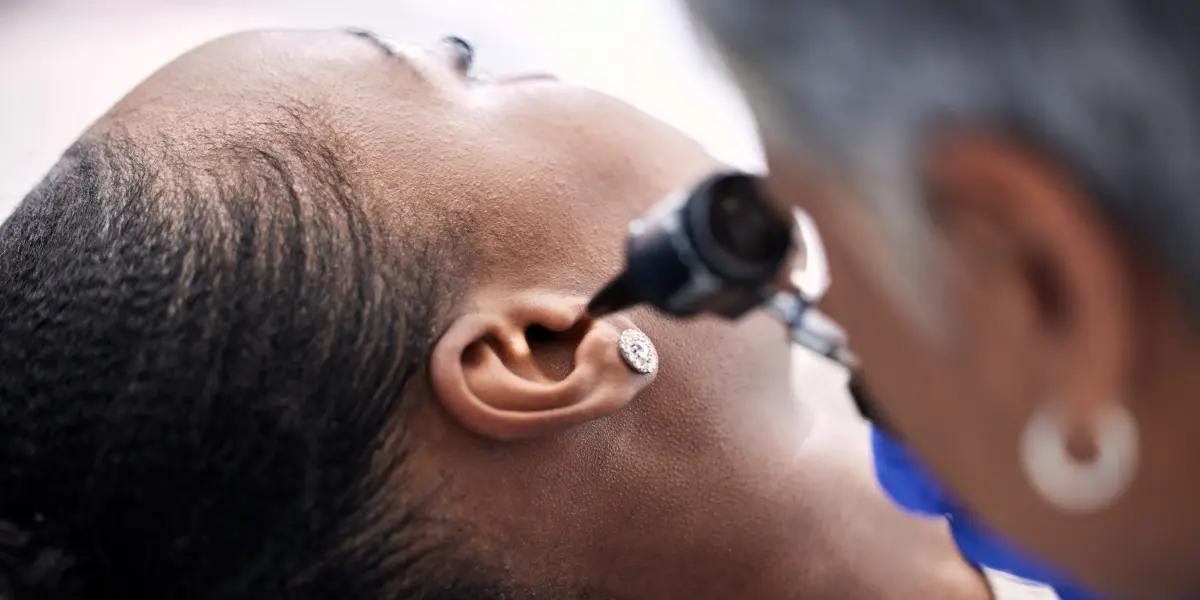 ENT doctor examining a woman's ear